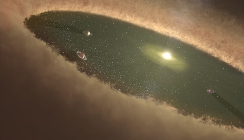 Impressão de artista de um sistema estelar jovem mostra que os gigantes gasosos se formam primeiro, enquanto a nebulosa ainda está presente. 