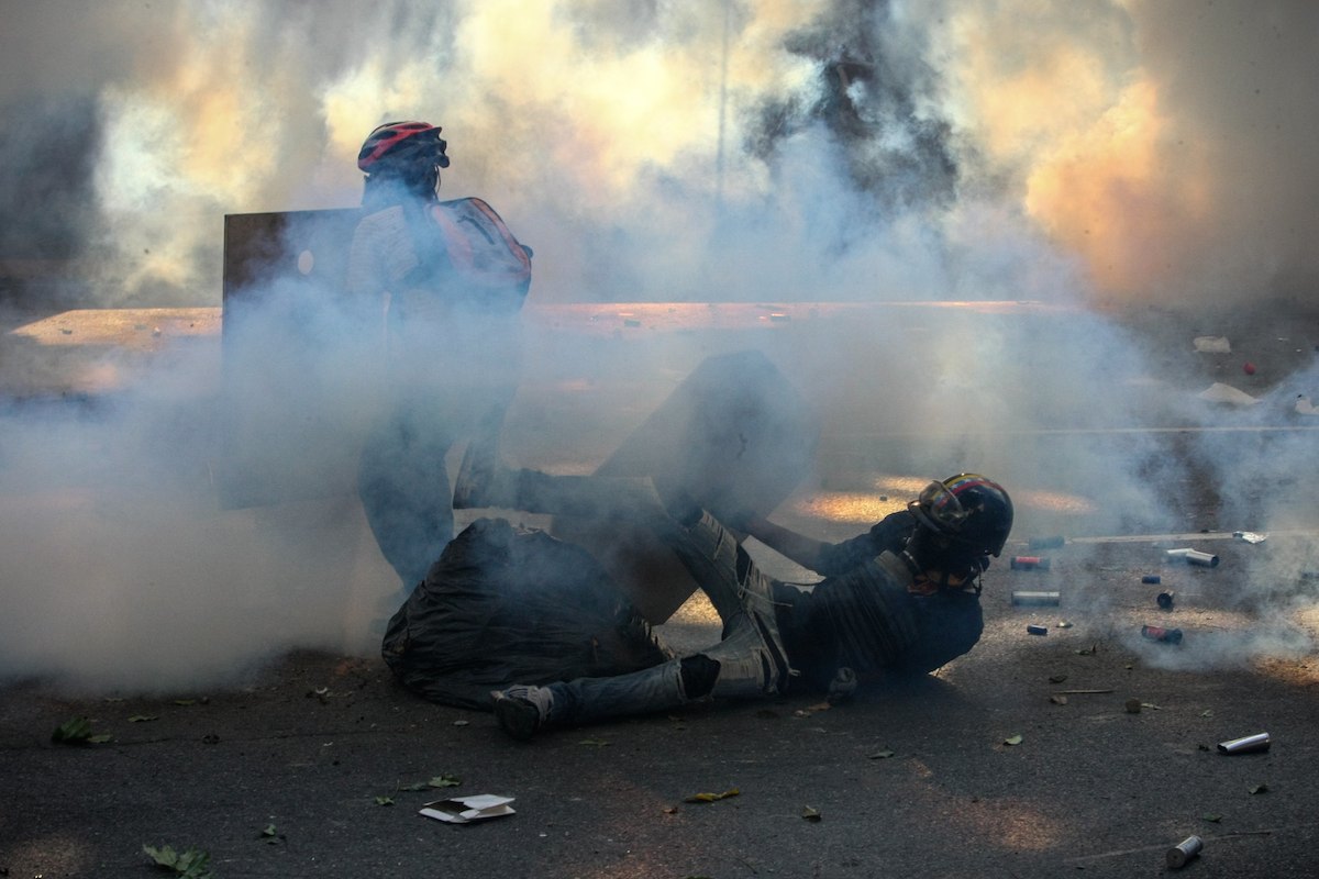 Grupo de manifestantes enfrenta a Guarda Nacional Bolivariana em protesto contra o presidente da Venezuela